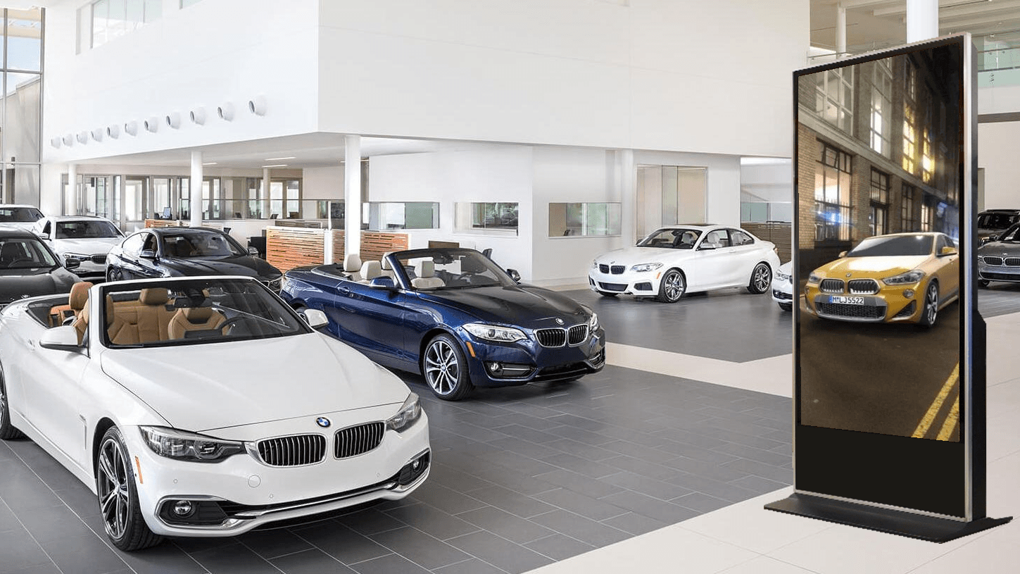 Car Dealership with Digital Kiosk displaying car advertisement